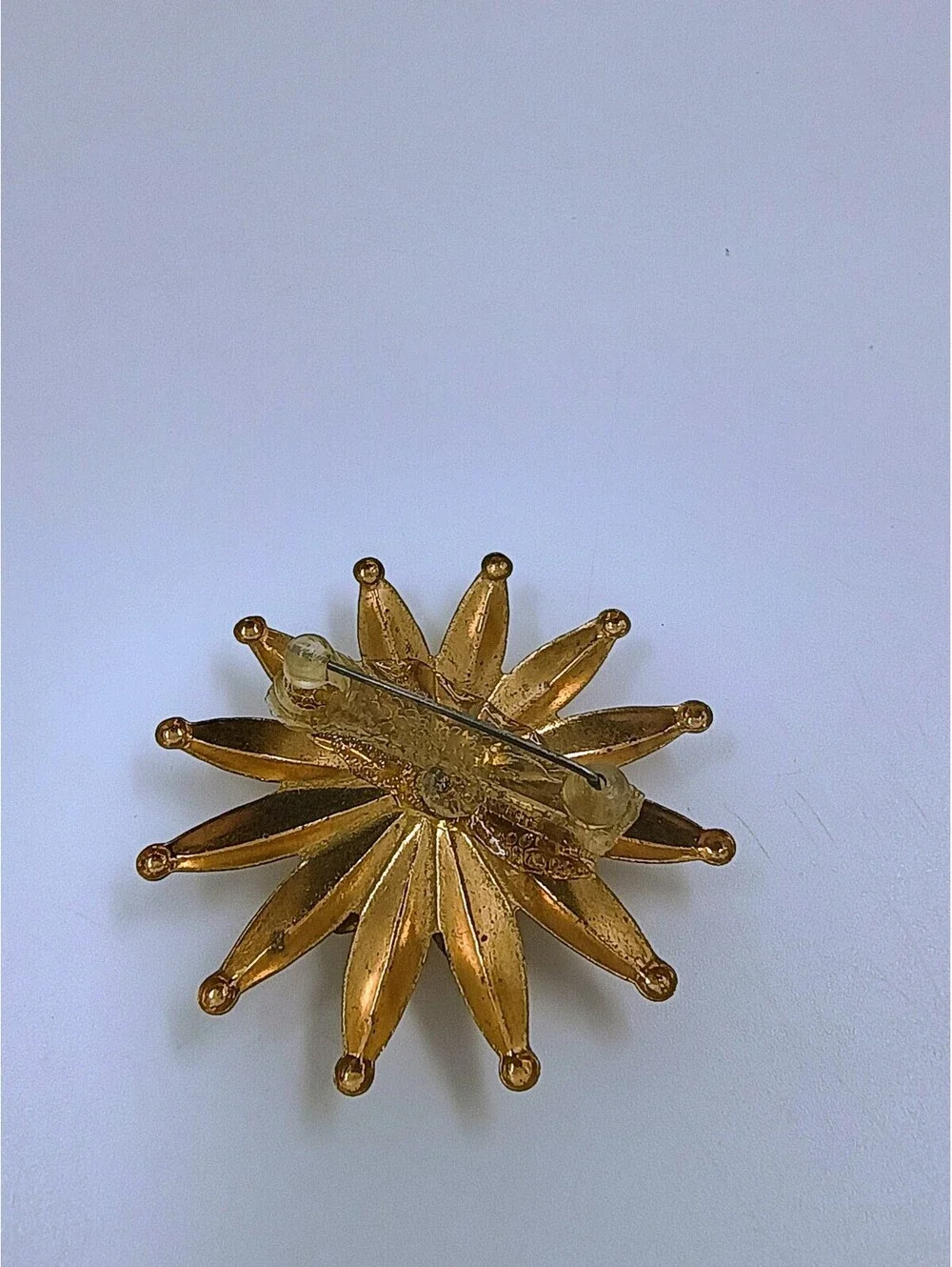 Vintage Gold-Tone Starburst Brooch with Green Center Stone